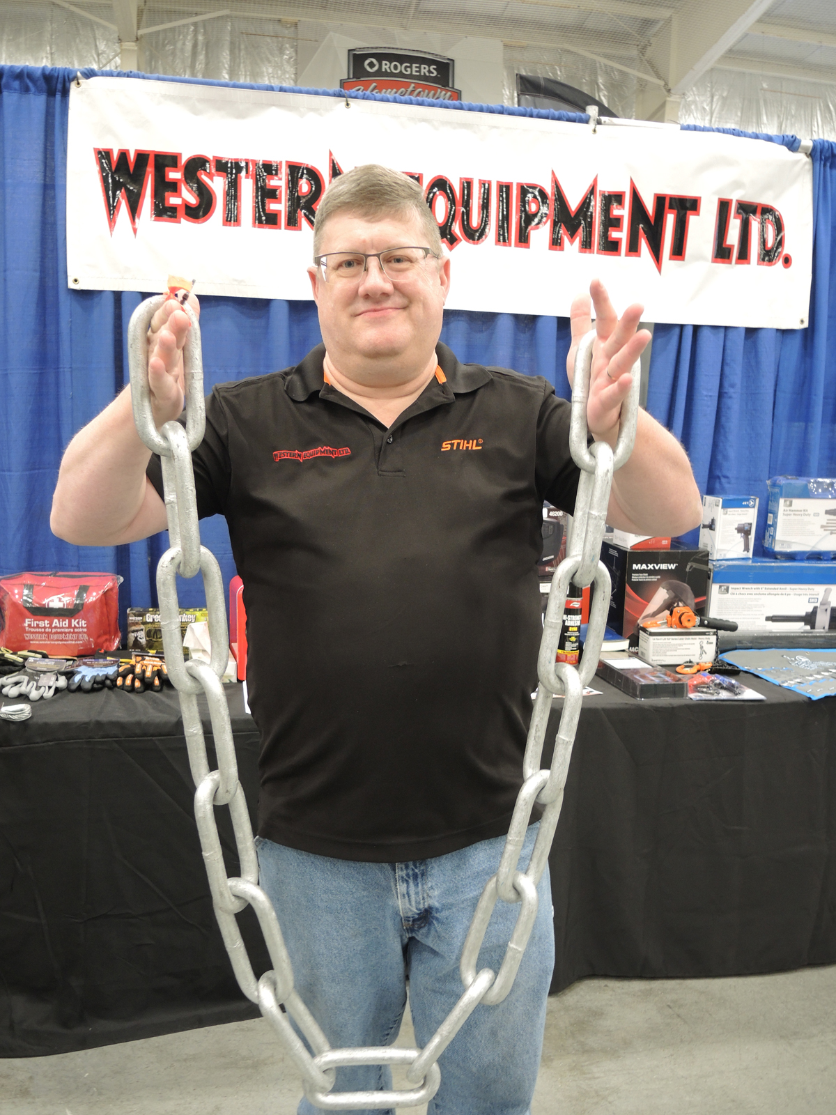 John McLaren of Western Equipment Ltd., displays a longlink mooring chain at the Ship to Shore Industrial Trade Show, at Wurtele Arena on Aug. 1. Credit: Peter Mallett/Lookout Newspaper