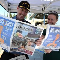 Captain (Navy) Kevin Whiteside, Base Commander of CFB Esquimalt, reads through a copy of the Lookout Newspaper with Jazmin Holdway, Lookout Manager at the Ship to Shore Industrial Trade Show at Wurtele Arena on Aug. 1. Photos: Peter Mallett/Lookout Newspaper