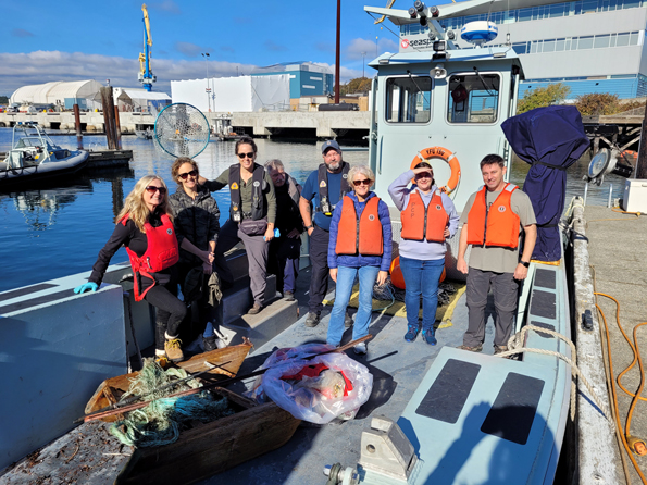 Members of the Harbour Shoreline Cleanup team gather at the Small Boats Jetty in Naden for a group photo following the successful completion of their mission. 
Photos: Peter Mallett/Lookout Newspaper