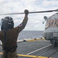 His Majesty's Canadian Ship (HMCS) Vancouver's embarked CH-148 Cyclone helicopter lands on the flight deck after completing regular flying while on Exercise ANNUALEX in the Philippine Sea on 14 November 2023. Photo credit: Corporal Alisa Strelley, Canadian Armed Forces Photo