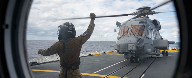 His Majesty's Canadian Ship (HMCS) Vancouver's embarked CH-148 Cyclone helicopter lands on the flight deck after completing regular flying while on Exercise ANNUALEX in the Philippine Sea on 14 November 2023. Photo credit: Corporal Alisa Strelley, Canadian Armed Forces Photo