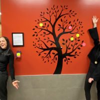 Danielle Yole and Ashley Evans of the MARPAC Health & Wellness Strategy Mental Social Wellness Working Group pose with the newly erected Gratitude Tree at Fleet Maintenance Facility Cape Breton.