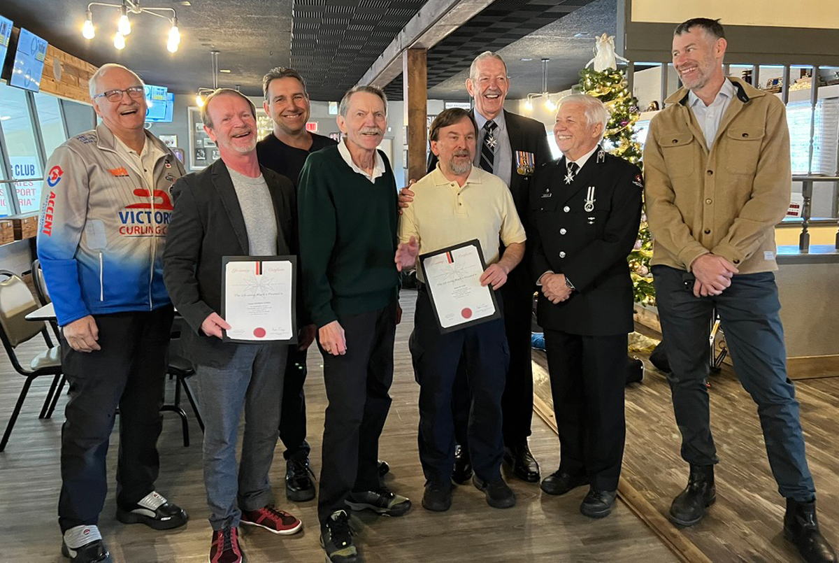 Life-saving Award: (Left) Paul Addison, Victoria Curling Club President, Lieutenant-Colonel Andrew Currie, Canadian Forces Health Services Pacific Region Surgeon, Paul Rober, Sportsman League President, Keith North, Doug Butler, E. David Hodgins and Ross Nichols, St. John Ambulance members, and James Keogh, Victoria Curling Club General Manager, gather for the award presentation at the Victoria Curling Club, Dec. 16, 2023. Photo: Don Allan