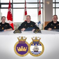 L–R: Commander Coates, Commodore Mazur, and Commander Bergmann signing papers at the Change of Command ceremony held at the Wardroom at Canadan Forces Base Esquimalt on Feb. 7. Photo: Corporal Tristan Walach, MARPAC Imaging Services.
