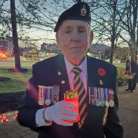 Top: Chief Petty Officer 1st Class (ret’d) John Robert Bourdage holds a candle during a Battle of Vimy Ridge Candlelit Tribute, Apr. 9, at Veterans Memorial Park in Langford.