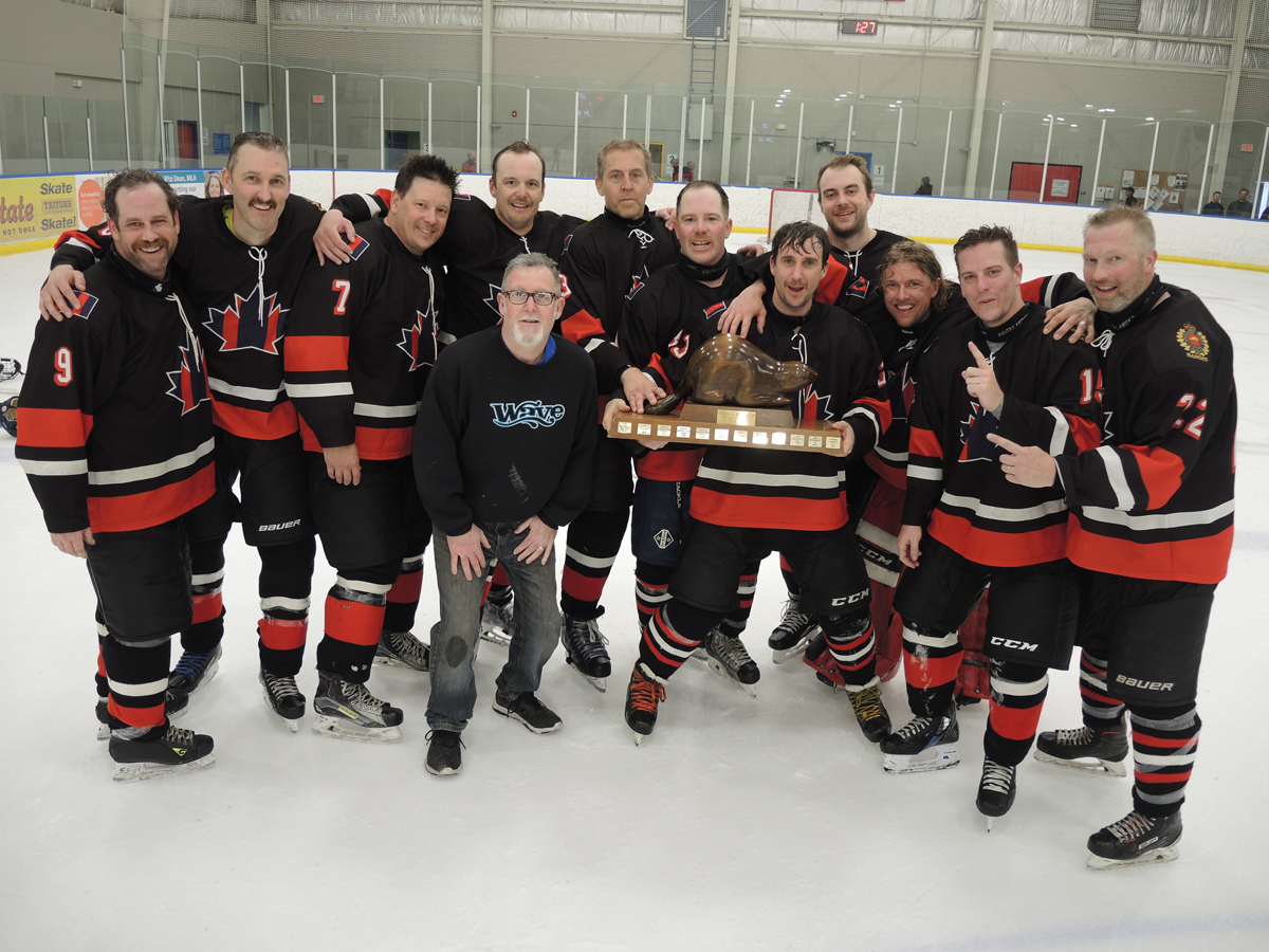 Members of the Bandits celebrate their victory following the conclusion of the Beaver Cup hockey tournament at Wurtele Arena, Apr. 19. The Bandits beat the Sappers 2-1 in the championship game. Photo: Peter Mallett/Lookout Newspaper.